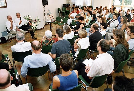 1999 · Cortona. The room gathers around a question