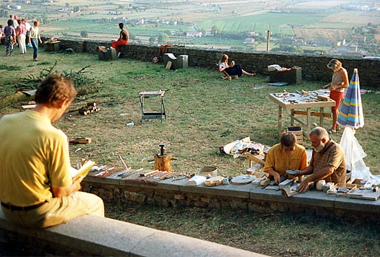 Participants work with materials outdoors on the hillside above the valley.