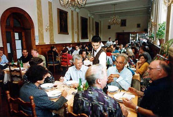 Participants from different generations share a meal in the monastery dining room.
