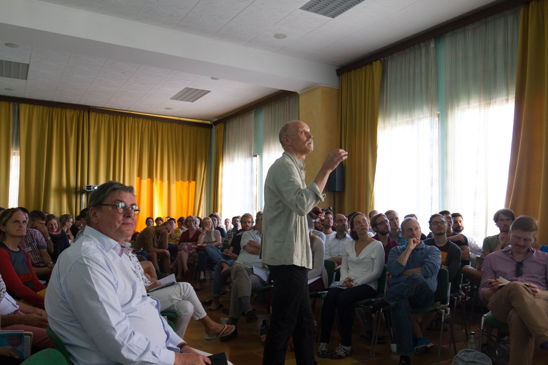 Two speakers and participants in a morning lecture room at Cortona Week.